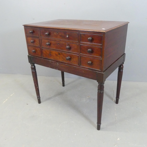 2573 - A Victorian mahogany gentleman's dressing table on stand with 5 drawers, the lifting lid revealing a... 