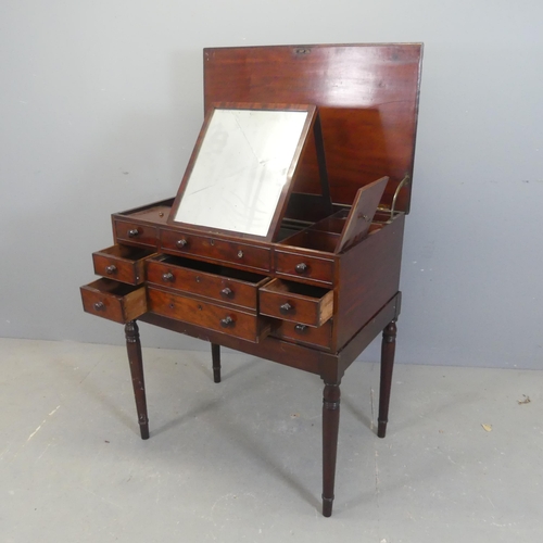 2573 - A Victorian mahogany gentleman's dressing table on stand with 5 drawers, the lifting lid revealing a... 