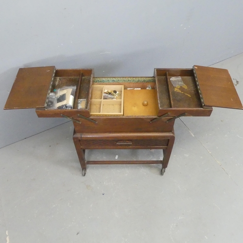 2580 - A 1930s oak cantilever sewing box. Width 49cm, height 57cm, depth 31cm.