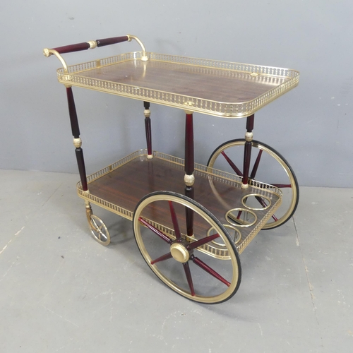 2582 - A mid-century style two-tier bar cart / drinks trolley, with rosewood veneered tops and pierced bras... 