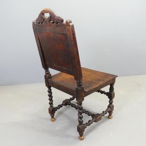 2604 - A 17th century style oak chair, with carved decoration and barley twist supports.