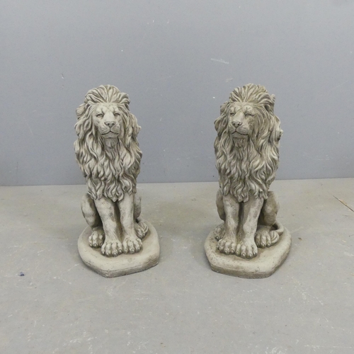 2608 - A pair of concrete garden lion statues. Height 42cm.