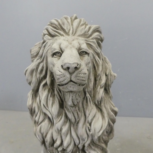 2608 - A pair of concrete garden lion statues. Height 42cm.