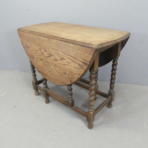 2619 - An antique oak oval gate-leg drop-leaf table with barley twist supports. Length 91cm, height 73cm, d... 