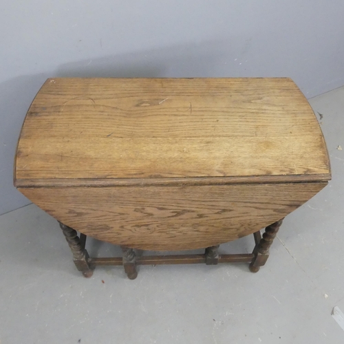 2619 - An antique oak oval gate-leg drop-leaf table with barley twist supports. Length 91cm, height 73cm, d... 