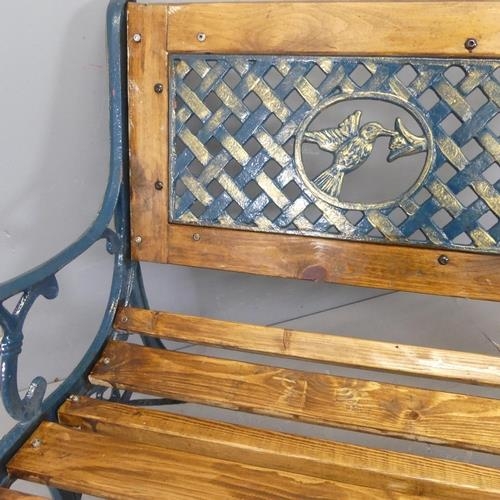 2621 - A pine slatted garden bench, with inset painted cast iron panel depicting hummingbirds and woven des... 