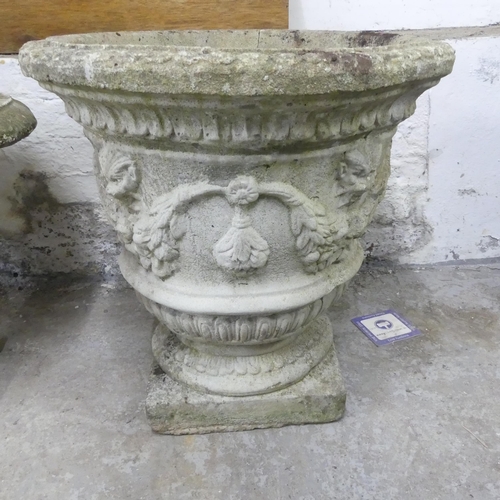 2641 - A weathered concrete garden urn on plinth base, with lion mask and foliate decoration. Diameter 50cm... 