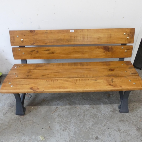 2644 - A pine garden bench on cast iron frame. Length 138cm, height 77cm, depth 60cm.