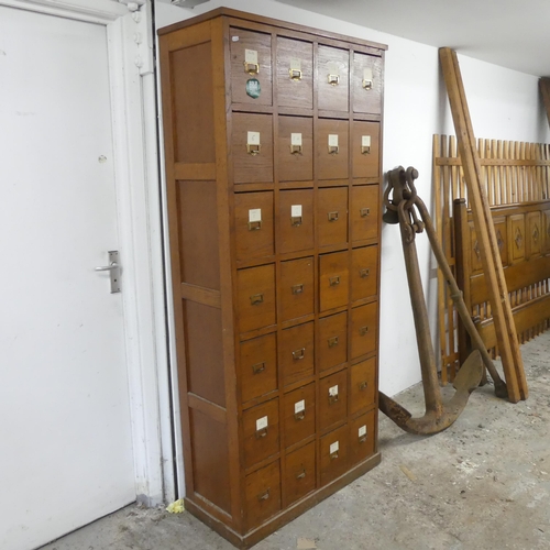 2645 - A vintage French oak notaire cabinet, with 28 drawers. Width 82cm, height 180cm, depth 36cm.