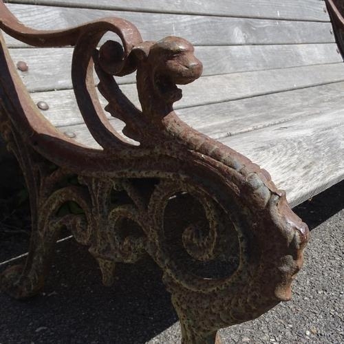 2650 - A teak slatted garden bench, with heavy Georgian style cast iron ends. 158x73x80cm.