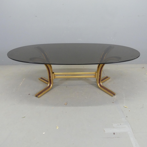 2656 - A mid-century style oval coffee table in the manner of Gordon Russell, with oval smoked glass top on... 