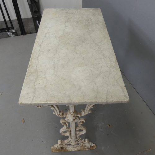 2659 - A rectangular marble topped garden table on painted cast iron frame. Length 106cm, height 70cm, widt... 