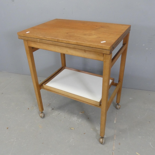 2666 - A mid-century teak two-tier tea trolley, with fold-over top and labelled for Nathan Furniture. Lengt... 