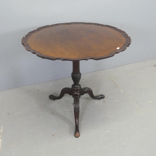 2667 - A reproduction mahogany circular occasional table, with piecrust edge, turned central column and tri... 