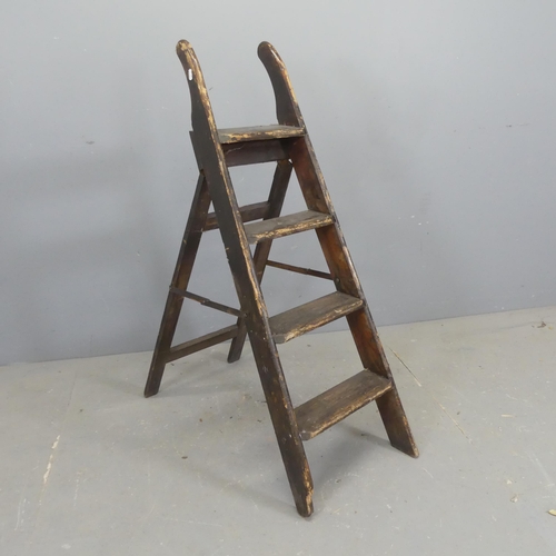 2679 - A vintage stained pine step ladder. Height 114cm (deployed).