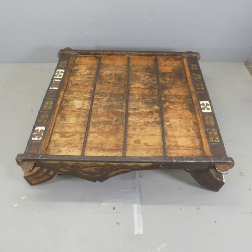 2686 - An Moroccan hardwood and metal bound square-topped low table. Width 130cm, height 36cm.