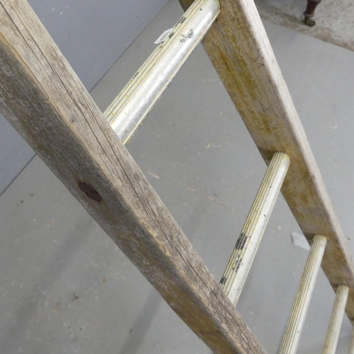 2700 - A vintage fruit picking ladder. Length 255cm.