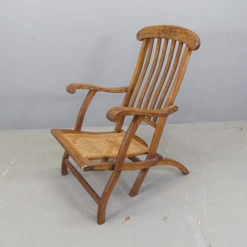 2706 - A folding cane seated steamer chair, inscribed 