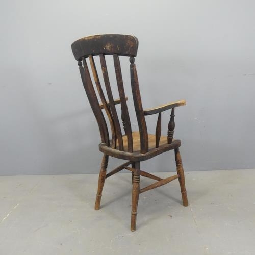 2709 - An antique elm-seated Windsor kitchen arm chair.