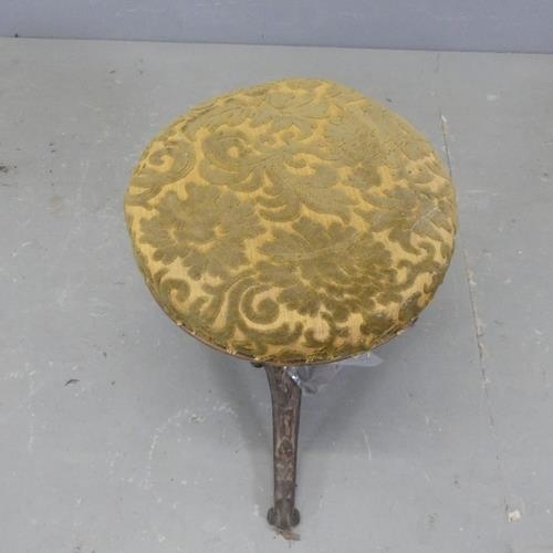 2720 - An antique upholstered footstool on cast iron frame, with rise and fall mechanism. A/F.