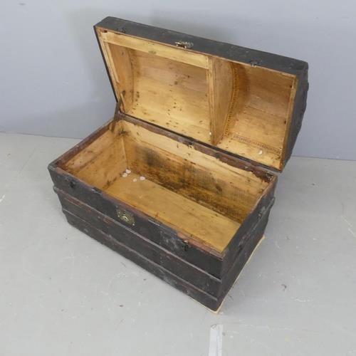 2727 - A Victorian leather covered and metal bound pine dome-top trunk. W88cm, H60cm, D49cm.