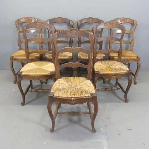 2733 - A matched set of seven French oak ladder-back rush-seated dining chairs.