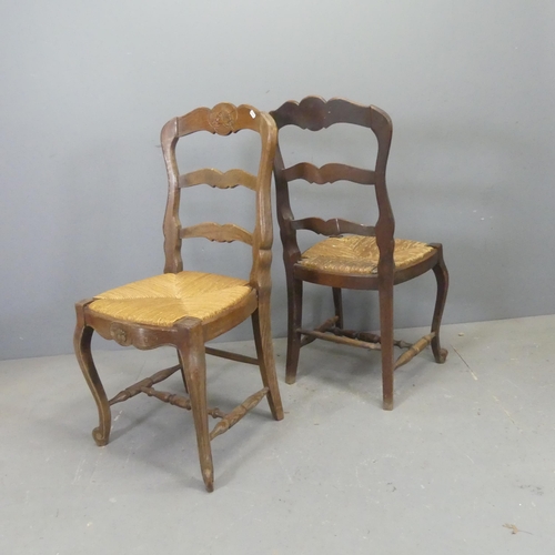 2733 - A matched set of seven French oak ladder-back rush-seated dining chairs.