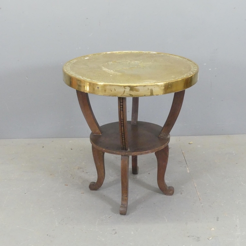 2734 - A modern oak and brass-topped circular side / lamp table, with repousse springbok decoration. D60cm,... 