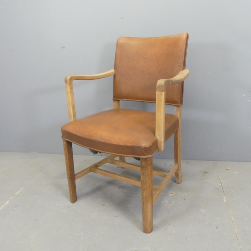 2736 - A French oak and faux-leather upholstered open arm bridge chair.