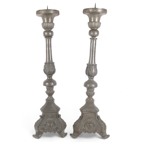 102 - A pair of large Antique Gothic style pewter pricket candlesticks, with embossed acanthus leaf scroll... 