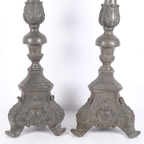 102 - A pair of large Antique Gothic style pewter pricket candlesticks, with embossed acanthus leaf scroll... 