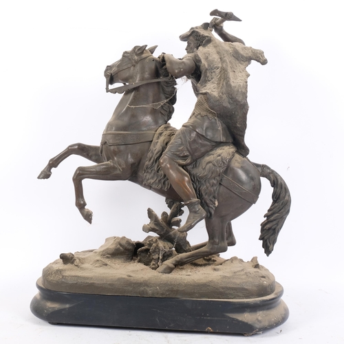 104 - A large spelter horse and warrior, on ebonised stand, H63cm