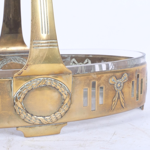 106 - An Art Deco brass fruit basket with glass liner, pierced stylised and embossed decoration, L32cm, H2... 