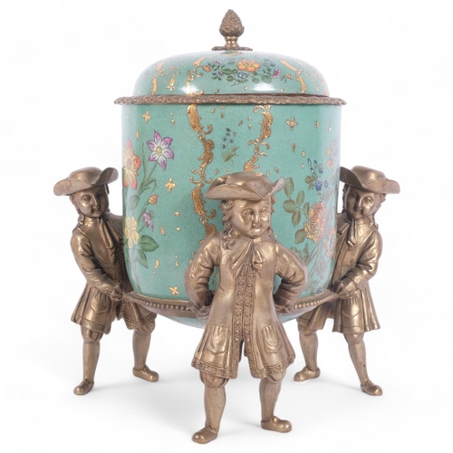 109 - A French style glazed ceramic cylindrical table box and cover, supported by brass figures with ormol... 