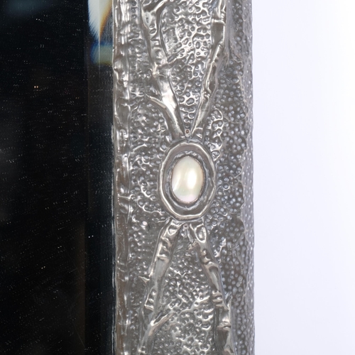 113 - An Art Nouveau pewter framed wall mirror, with floral repousse decoration and mother-of-pearl bosses... 