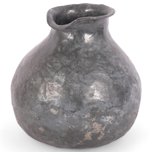 124 - A heavy hammered lead Ethnic pouring vessel, H19cm