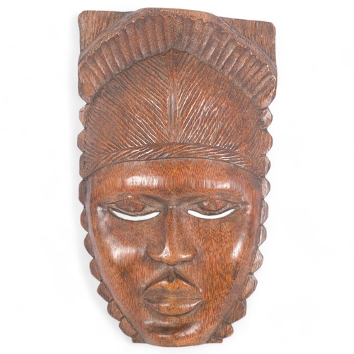 126 - A carved African hardwood mask, L40cm