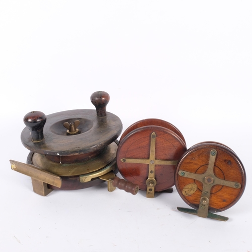 13 - A large Carter & Co, London walnut and brass fishing reel, diameter 18cm, and 2 other walnut and bra... 