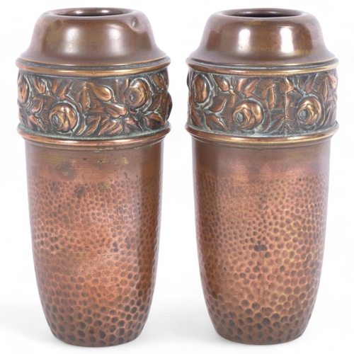 193 - A pair of Arts and Crafts hammered brass vases, with floral repousse border, H18cm