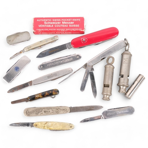 213 - A collection of various penknives, including a Swiss Army example, a Metropolitan whistle, etc