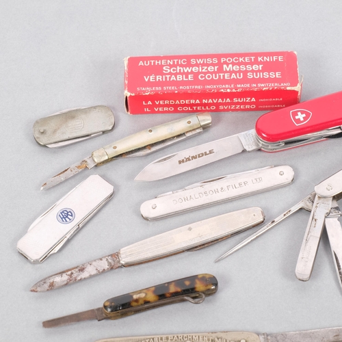 213 - A collection of various penknives, including a Swiss Army example, a Metropolitan whistle, etc