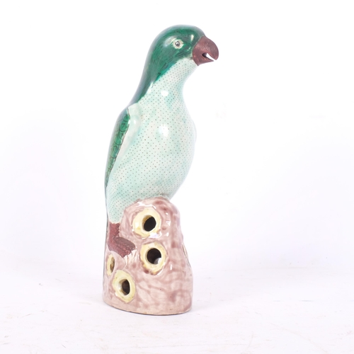 219 - A Chinese famille vert study of a parrot on pierced base, H23cm