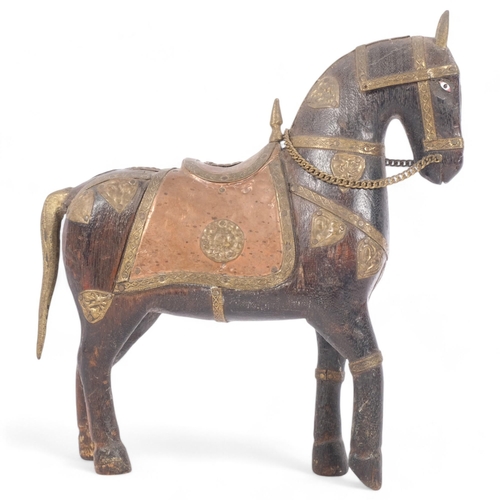 231 - A Middle Eastern carved hardwood ceremonial horse with brass and copper adornments, H20cm