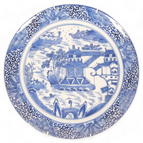 250 - A 19th century  Chinese blue and white plate, with pagoda decoration, diameter 24cm