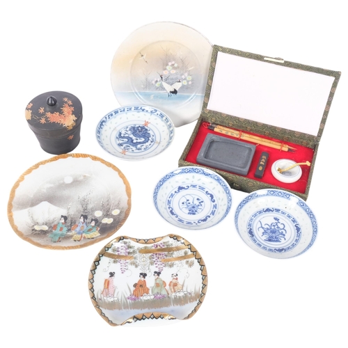 251 - A group of Oriental items, including blue and white rice dishes, cased travelling scribe's set, etc