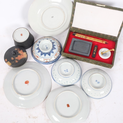 251 - A group of Oriental items, including blue and white rice dishes, cased travelling scribe's set, etc