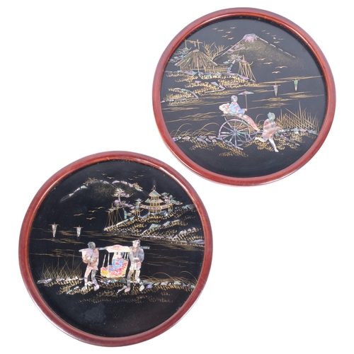 253 - A pair of Japanese black lacquered circular panels, decorated with Mount Fuji scenes with gilded and... 