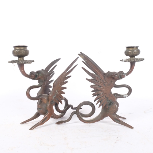 263 - A pair of bronze candle stands, with stylised dragon supports, H17cm