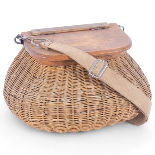 27 - An early 20th century handmade wicker fishing creel, with wooden lid and original strap, 33cm x 19cm... 