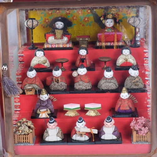 272 - A 20th century Japanese diorama, showing a display of Hinamatsuri Hina court dolls, in a stepped dis... 